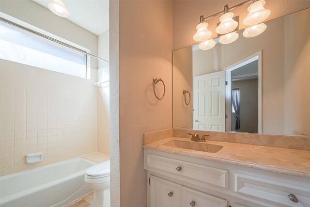 bathroom featuring toilet,  shower combination, a textured ceiling, and vanity