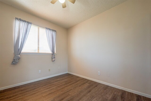 empty room featuring a ceiling fan, a textured ceiling, baseboards, and wood finished floors