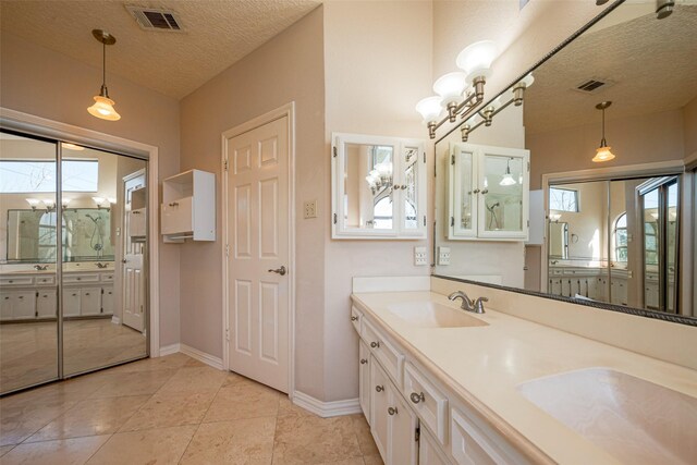 bathroom with plenty of natural light, a sink, and visible vents