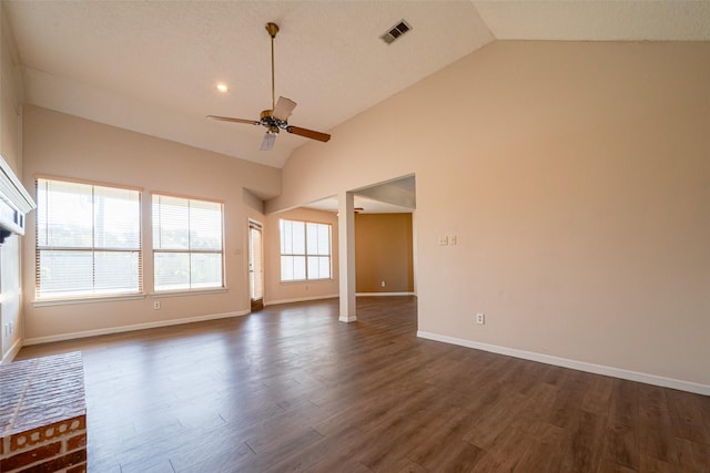 unfurnished room with high vaulted ceiling, dark wood-type flooring, visible vents, baseboards, and a ceiling fan