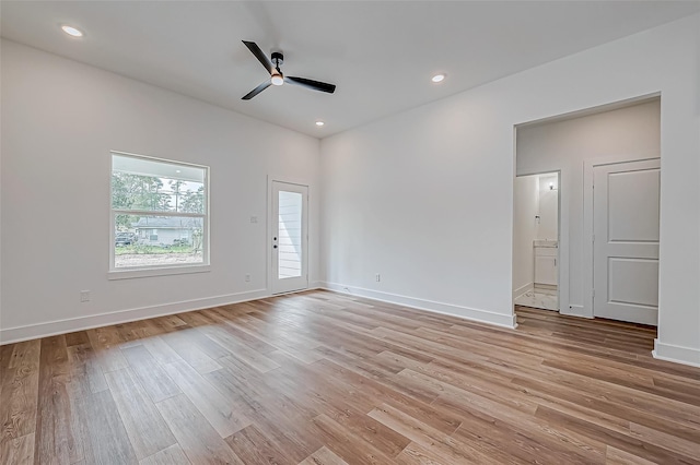 empty room featuring a ceiling fan, recessed lighting, light wood-style flooring, and baseboards