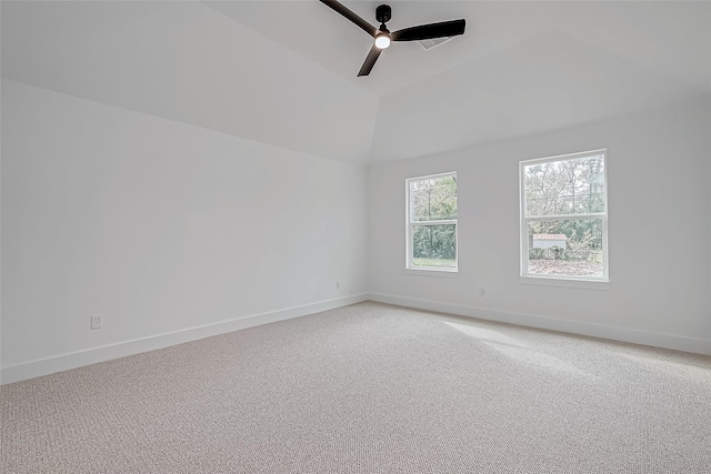 unfurnished room featuring ceiling fan, baseboards, vaulted ceiling, and light colored carpet