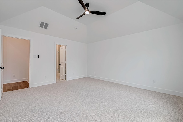 unfurnished room with visible vents, baseboards, vaulted ceiling, a ceiling fan, and carpet