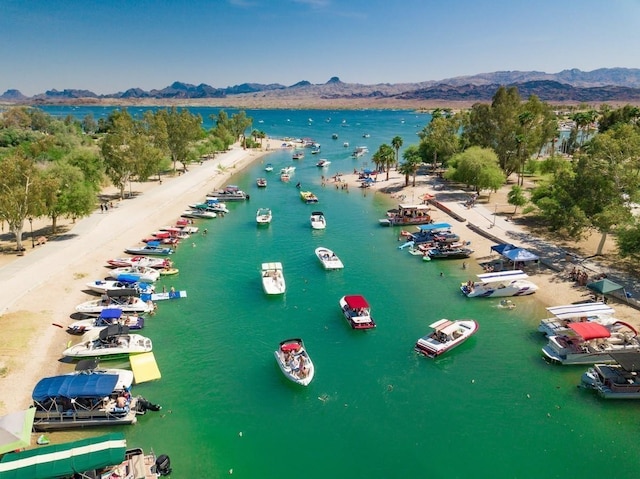 drone / aerial view featuring a water and mountain view