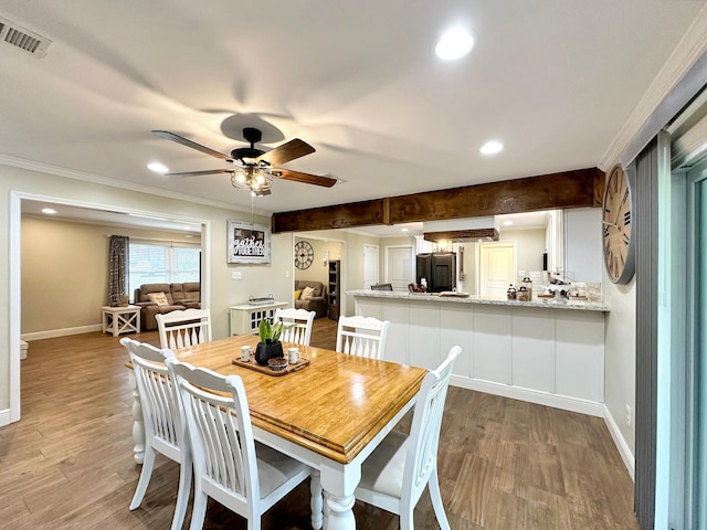 dining space featuring visible vents, baseboards, and wood finished floors