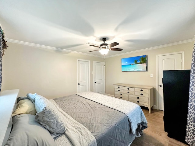 bedroom featuring a ceiling fan, crown molding, and light wood-style flooring