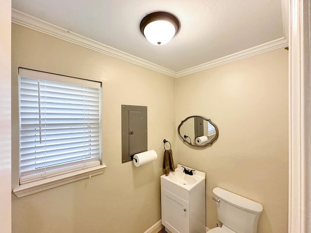 bathroom featuring electric panel, baseboards, toilet, crown molding, and vanity