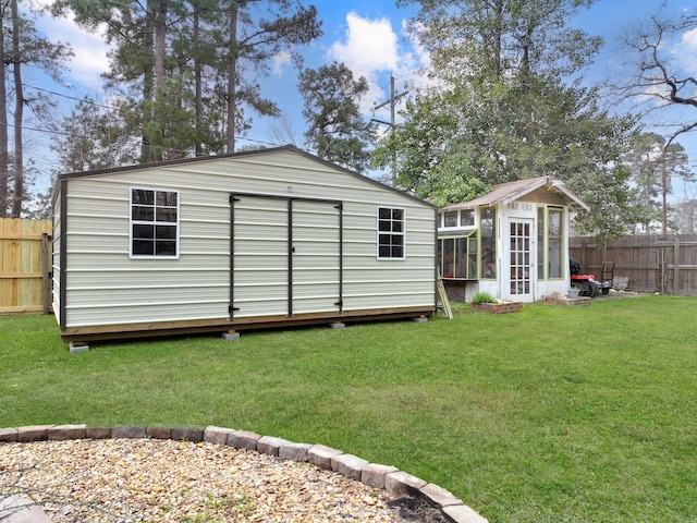 view of outdoor structure featuring an outbuilding and a fenced backyard