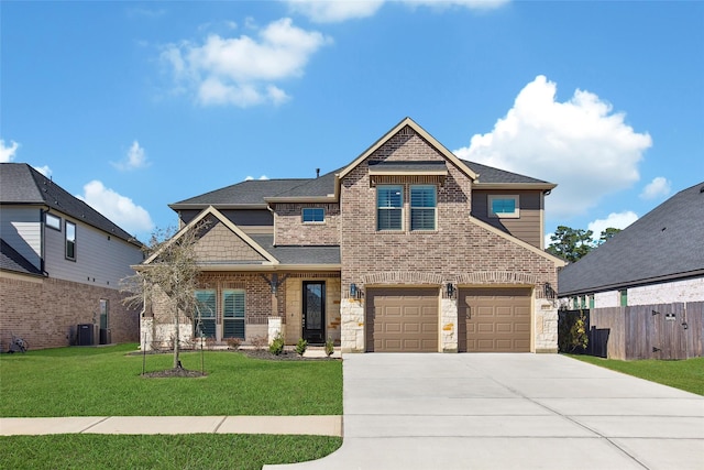 craftsman-style house with concrete driveway, brick siding, a front yard, and fence