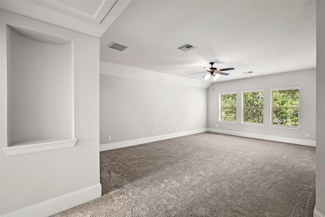 unfurnished room with carpet floors, visible vents, and baseboards