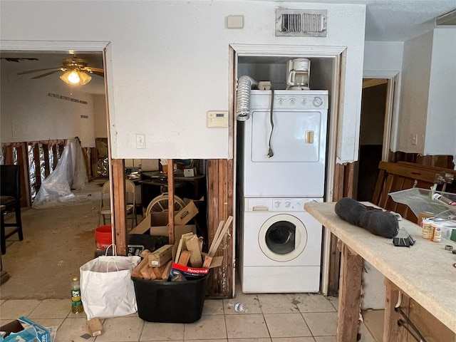 clothes washing area featuring light tile patterned floors, laundry area, a ceiling fan, visible vents, and stacked washer / drying machine