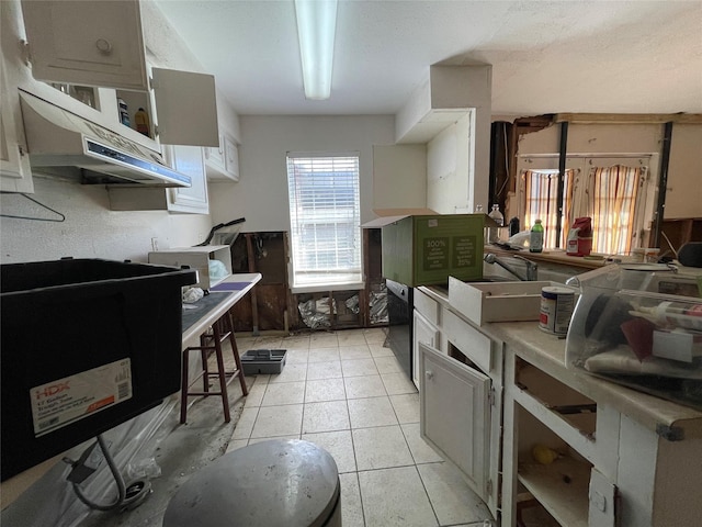 kitchen with light countertops, a sink, and light tile patterned floors