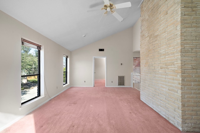 unfurnished living room with light colored carpet, visible vents, ceiling fan, high vaulted ceiling, and baseboards