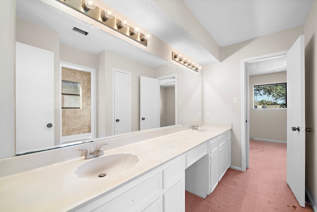 bathroom featuring visible vents, a sink, baseboards, and double vanity