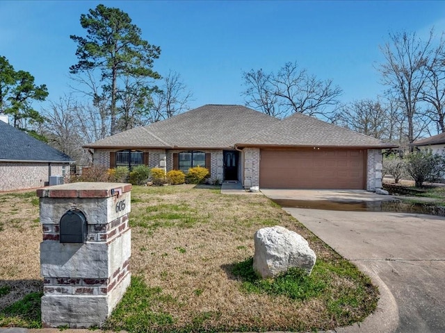 view of front facade featuring brick siding, a shingled roof, a front yard, a garage, and driveway