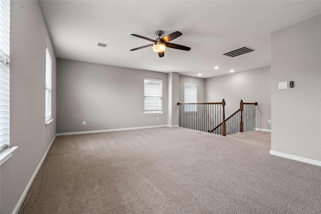 spare room with recessed lighting, visible vents, carpet flooring, ceiling fan, and baseboards