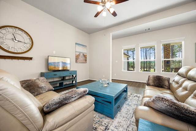 living room with ceiling fan, wood finished floors, visible vents, and baseboards