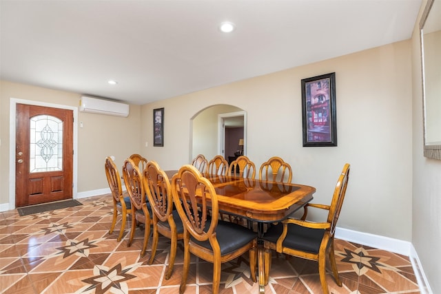 dining space featuring arched walkways, recessed lighting, a wall mounted air conditioner, and baseboards