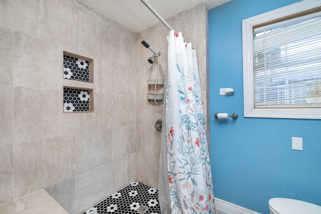 full bathroom featuring a textured wall, toilet, and a tile shower