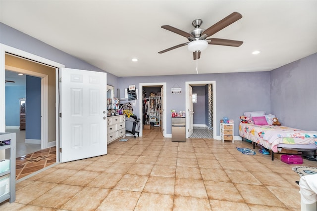 bedroom featuring ensuite bath, recessed lighting, baseboards, ceiling fan, and a spacious closet