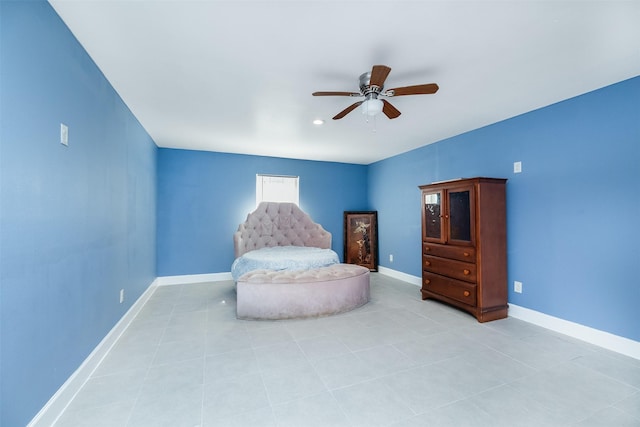 bedroom with baseboards, ceiling fan, and light tile patterned flooring