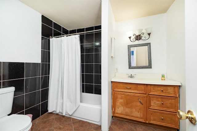 bathroom featuring tiled shower / bath, toilet, tile walls, tile patterned flooring, and vanity