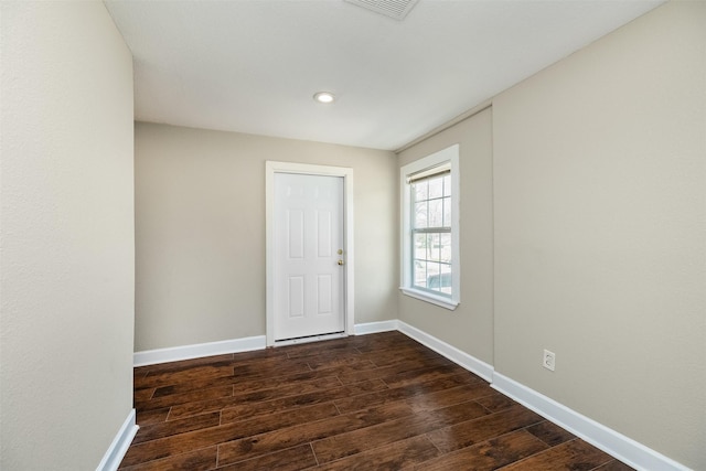 unfurnished room featuring visible vents, recessed lighting, baseboards, and dark wood-style flooring