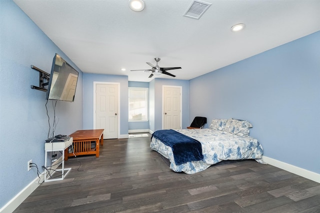 bedroom with visible vents, baseboards, and wood finished floors