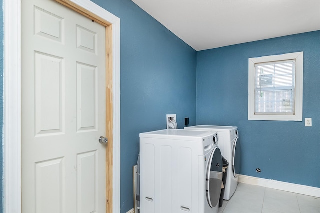 washroom with tile patterned flooring, laundry area, baseboards, and separate washer and dryer