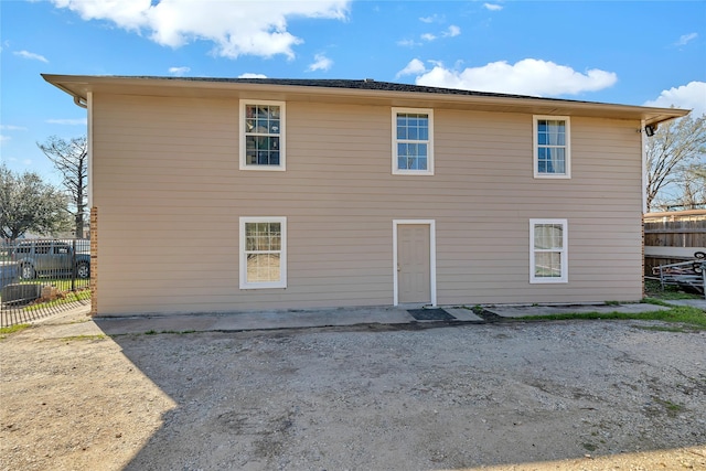 back of house featuring fence