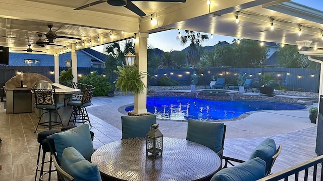 view of pool with outdoor dry bar, outdoor dining space, a fenced backyard, a fenced in pool, and an in ground hot tub