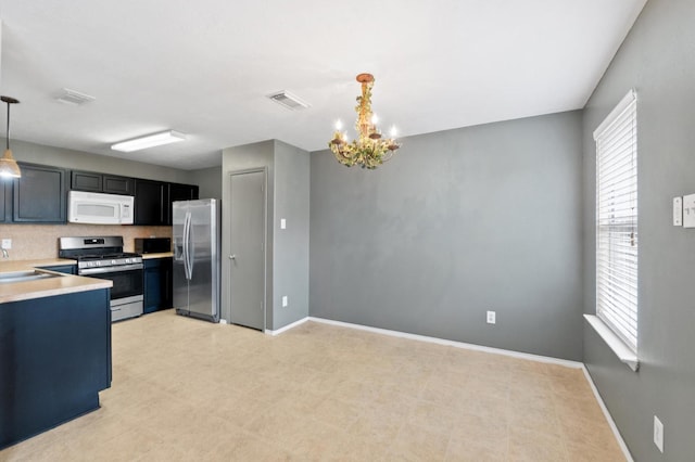 kitchen featuring visible vents, appliances with stainless steel finishes, light countertops, light floors, and a sink