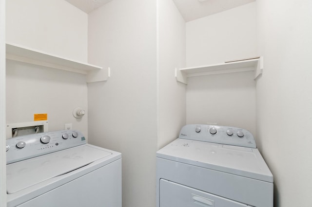 washroom with laundry area and washing machine and dryer