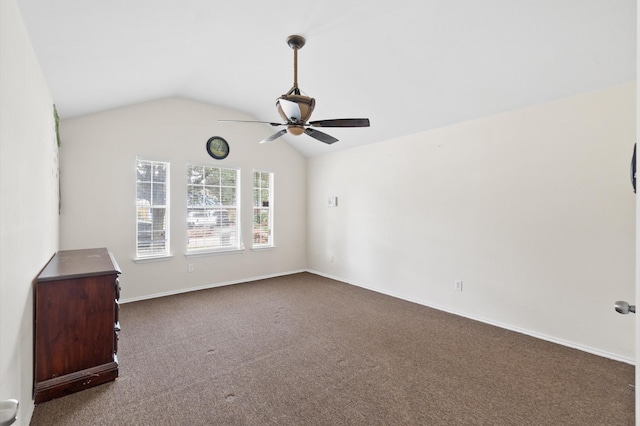 unfurnished room with ceiling fan, baseboards, vaulted ceiling, and dark colored carpet