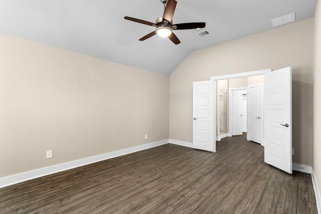 unfurnished bedroom with lofted ceiling, dark wood-style flooring, visible vents, and baseboards