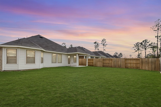 rear view of property with a lawn and fence private yard