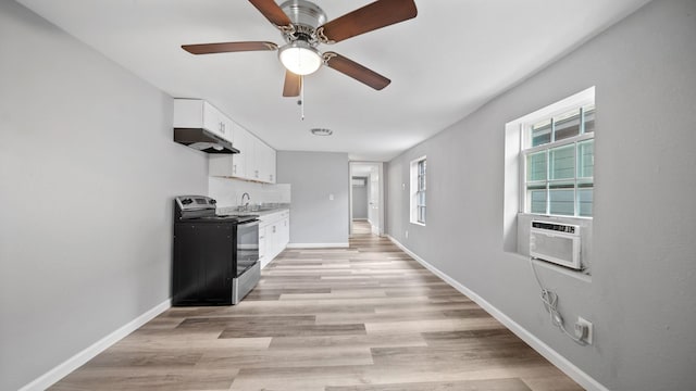 kitchen featuring white cabinets, cooling unit, under cabinet range hood, a sink, and range with electric stovetop