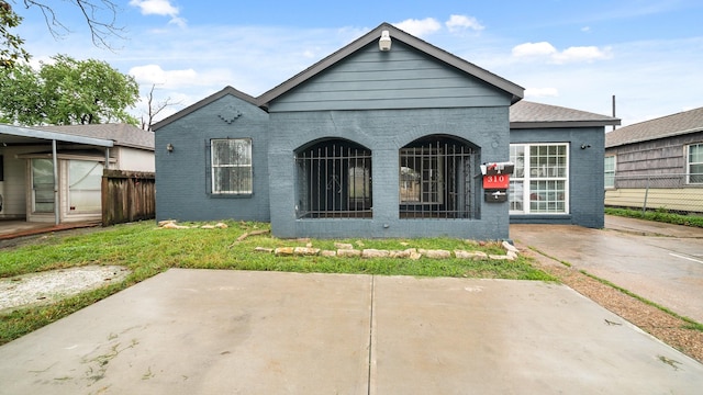 rear view of house with fence and brick siding