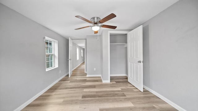 unfurnished bedroom featuring a closet, baseboards, ceiling fan, and light wood finished floors