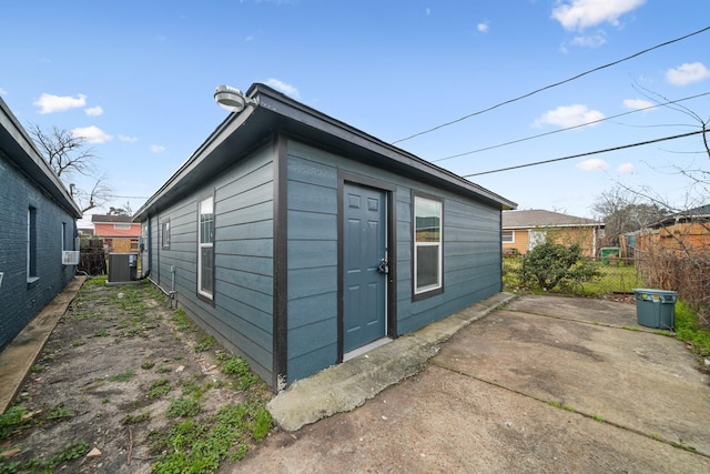 view of home's exterior featuring a patio area, fence, and central AC unit