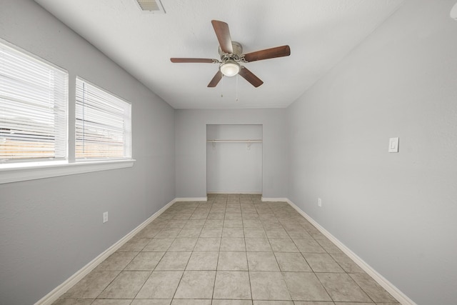 unfurnished room featuring a ceiling fan, visible vents, baseboards, and light tile patterned floors