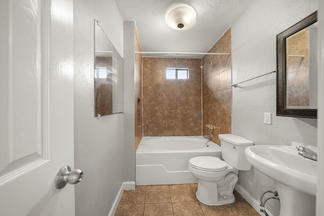 bathroom featuring a textured ceiling, bathtub / shower combination, toilet, and baseboards