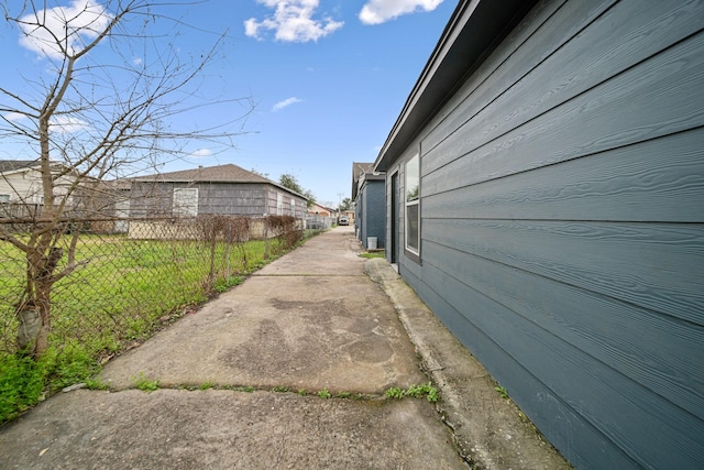 view of side of home featuring fence