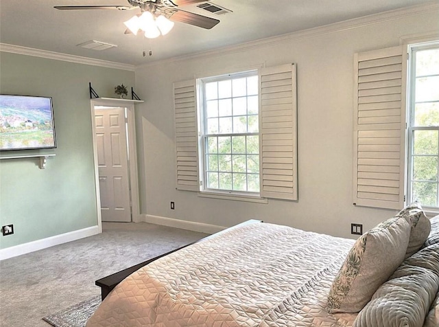 carpeted bedroom featuring ornamental molding, visible vents, baseboards, and multiple windows