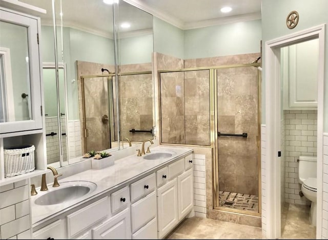 full bathroom with toilet, a stall shower, crown molding, and a sink