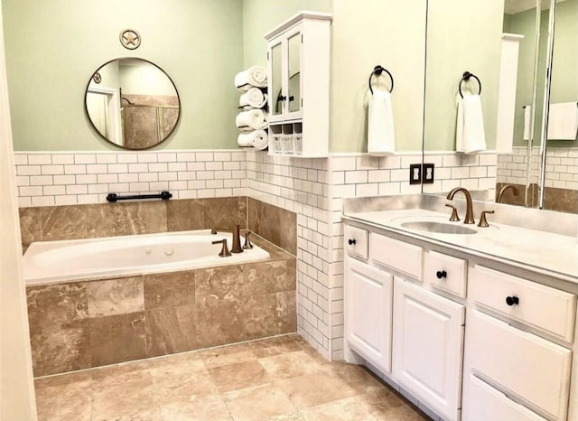 full bath featuring a garden tub and vanity