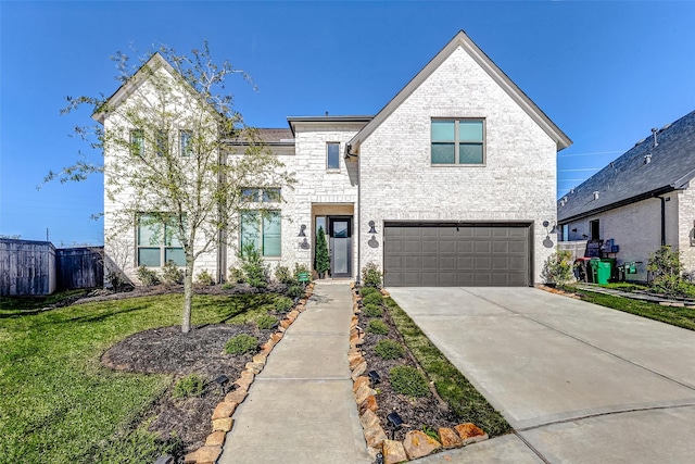 view of front of property with driveway, a garage, stone siding, fence, and a front lawn