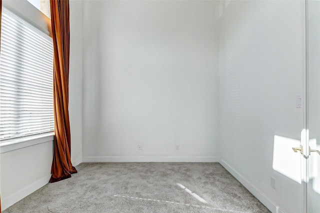 spare room with carpet floors and baseboards