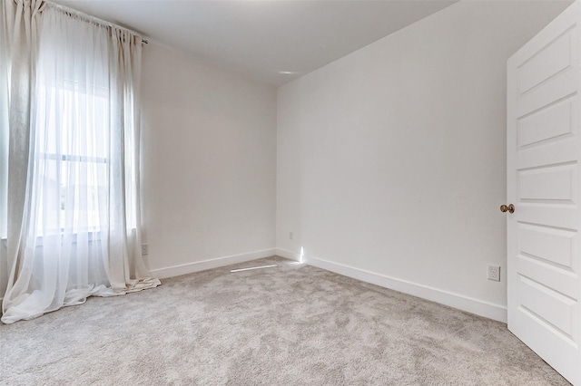 carpeted empty room with baseboards