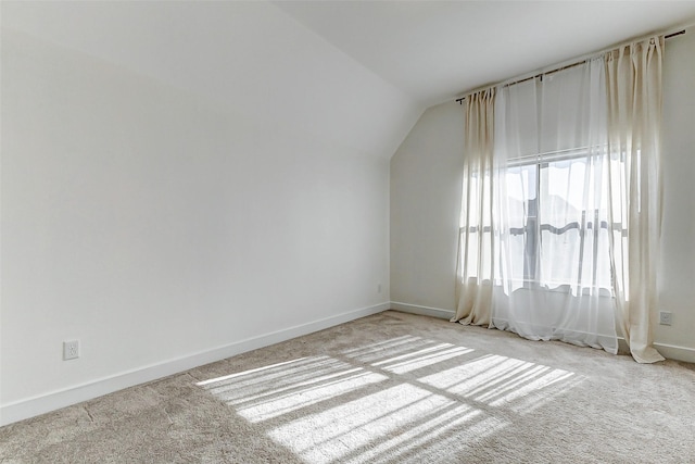 bonus room featuring baseboards, vaulted ceiling, and carpet flooring